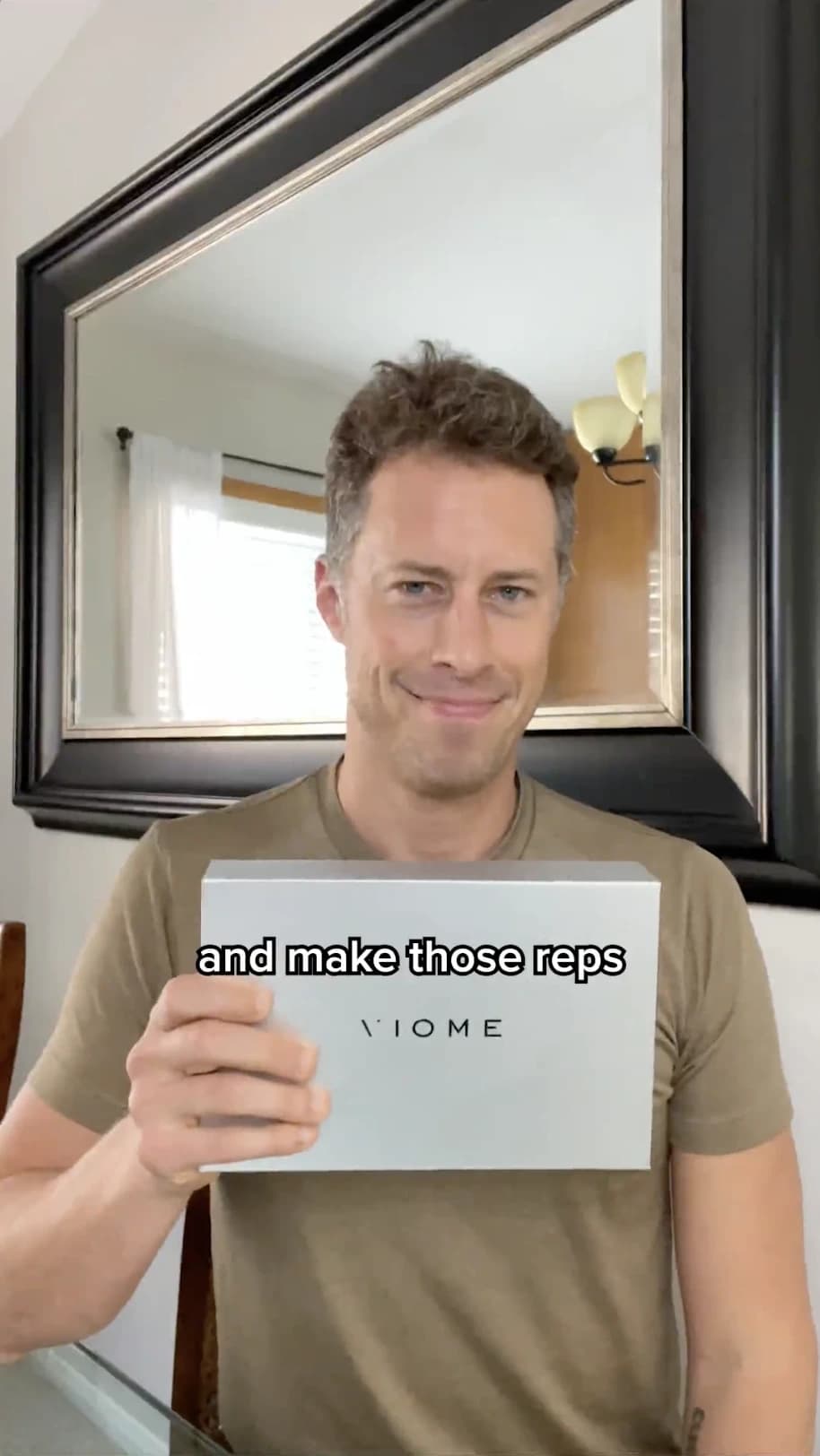 UGC creator holding up a product box while talking to camera at home