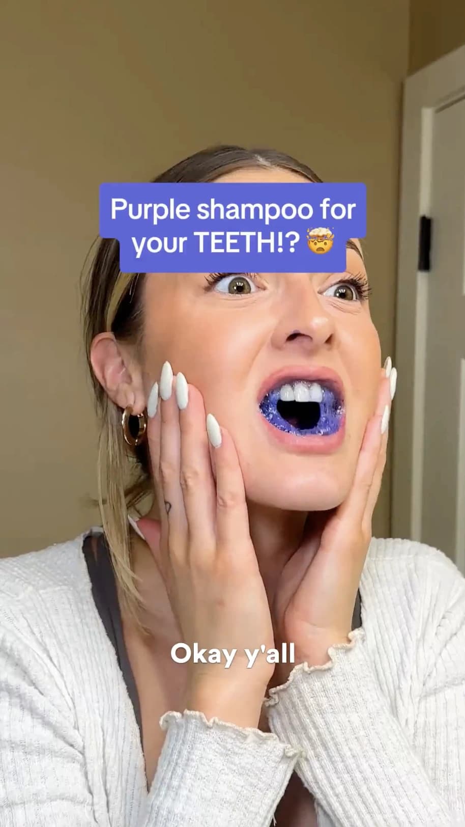 UGC creator reacting on camera after trying a purple teeth-whitening product